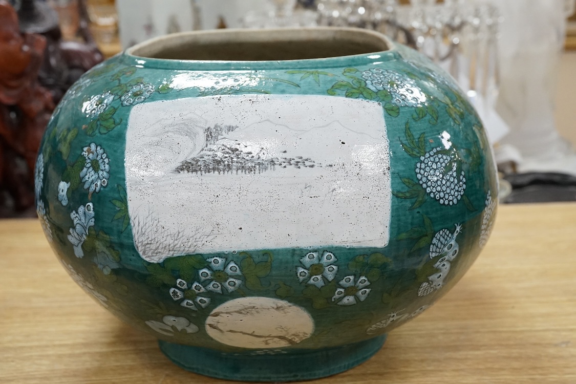 A Chinese enamelled porcelain oval bowl, Guandong kilns, early 20th century, green with en grisaille panels, 20cm high